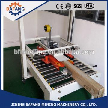 Semi-auto boxes sealing strapping machine